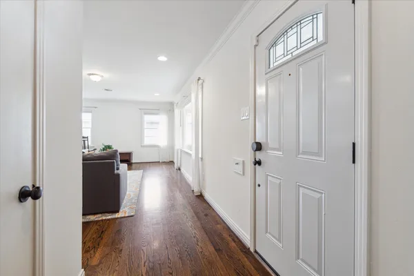 a view of a hallway with wooden floor and staircase