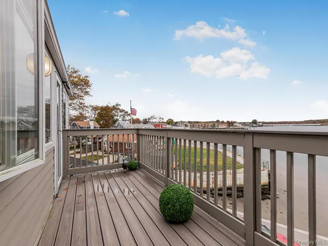 a view of a balcony with wooden floor