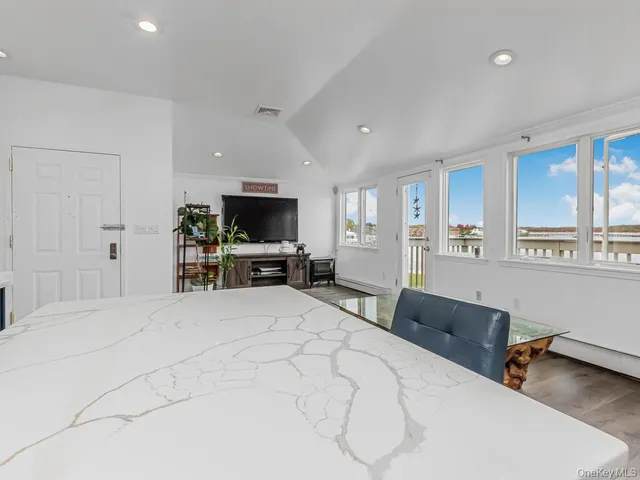 a large bedroom with a bed and a flat screen tv