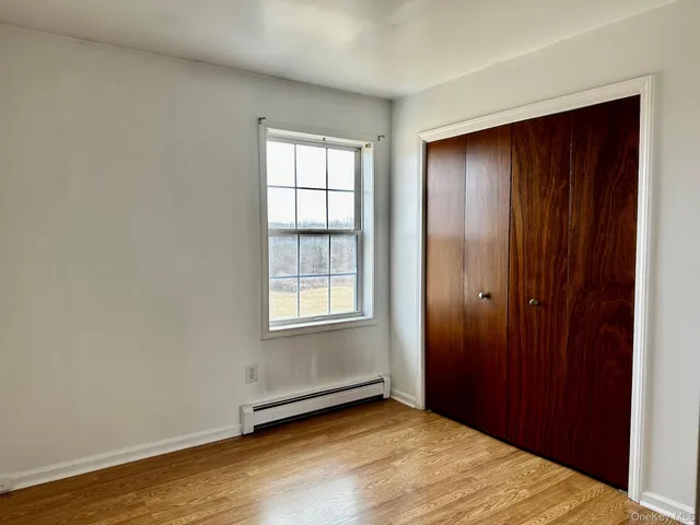 an empty room with windows and closet