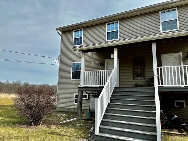 a front view of a house with wooden stairs