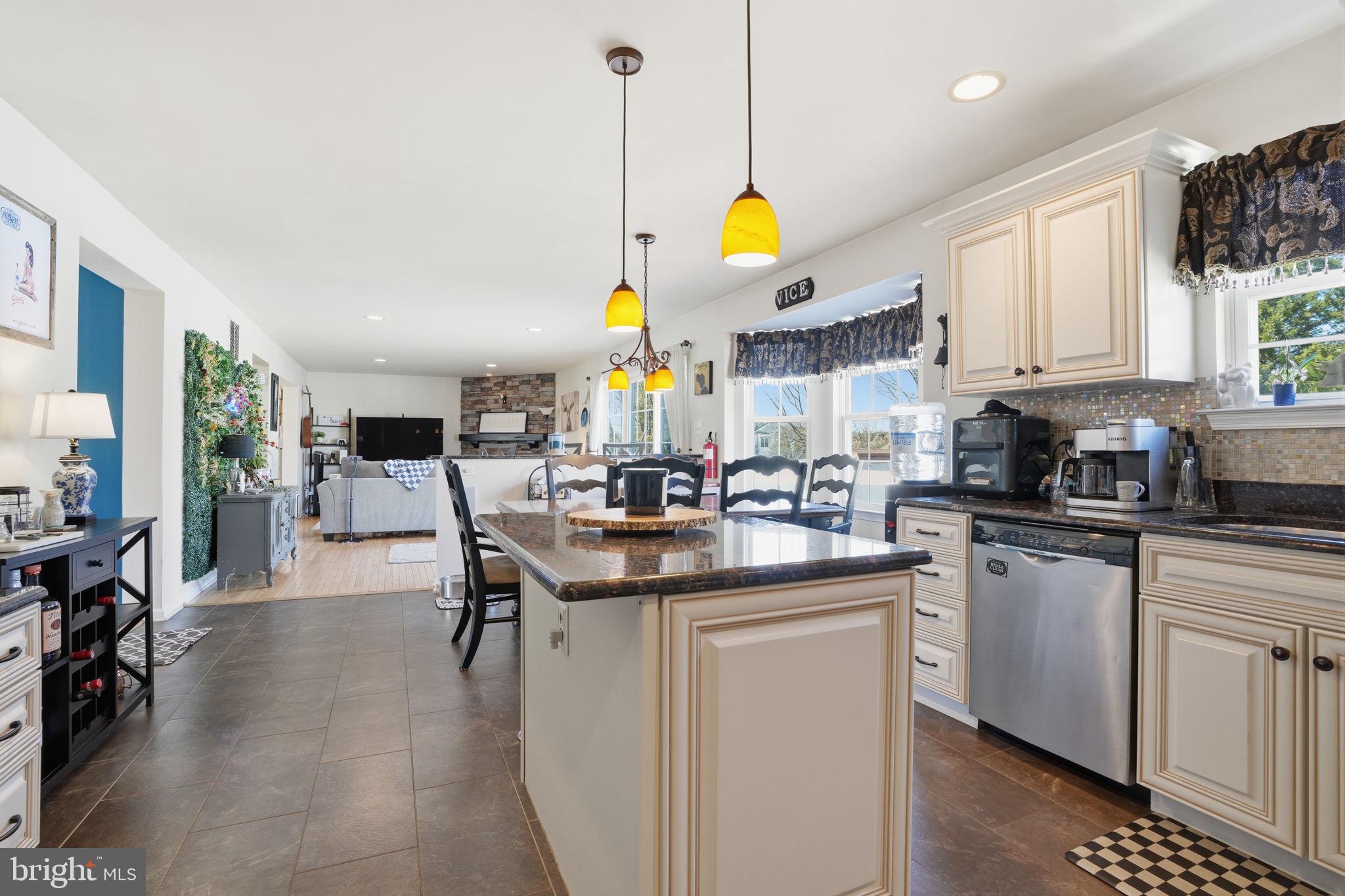 36 Moray Lane Sewell, NJ 08080 - Photo 11 of 40 a kitchen with stainless steel appliances granite countertop a sink a stove cabinets and living room view