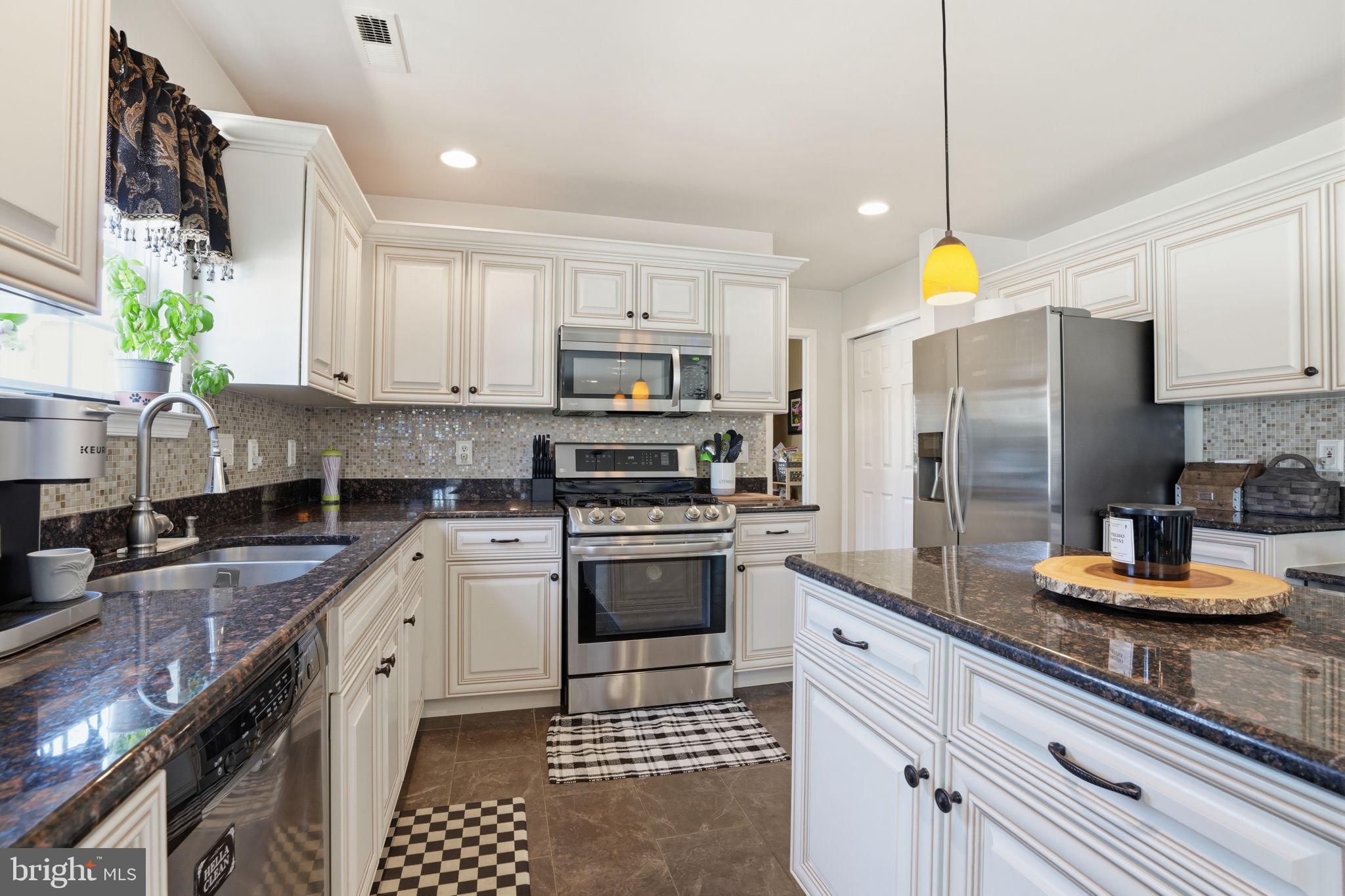 36 Moray Lane Sewell, NJ 08080 - Photo 12 of 40 a kitchen with kitchen island granite countertop a sink appliances cabinets and counter space