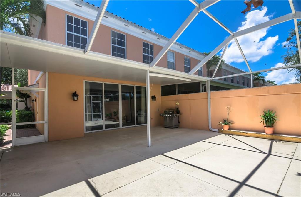 5441 Cove Circle Naples, FL 34119 - Photo 14 of 25 a backyard of a house with table and chairs