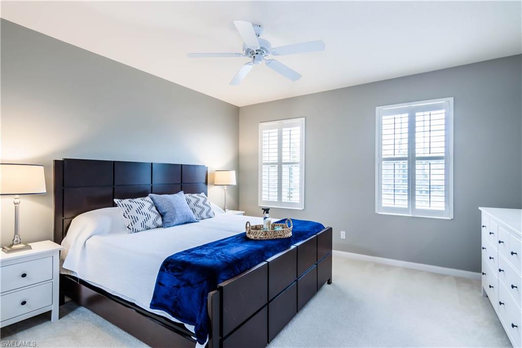 5441 Cove Circle Naples, FL 34119 - Photo 19 of 25 a bedroom with bed and window