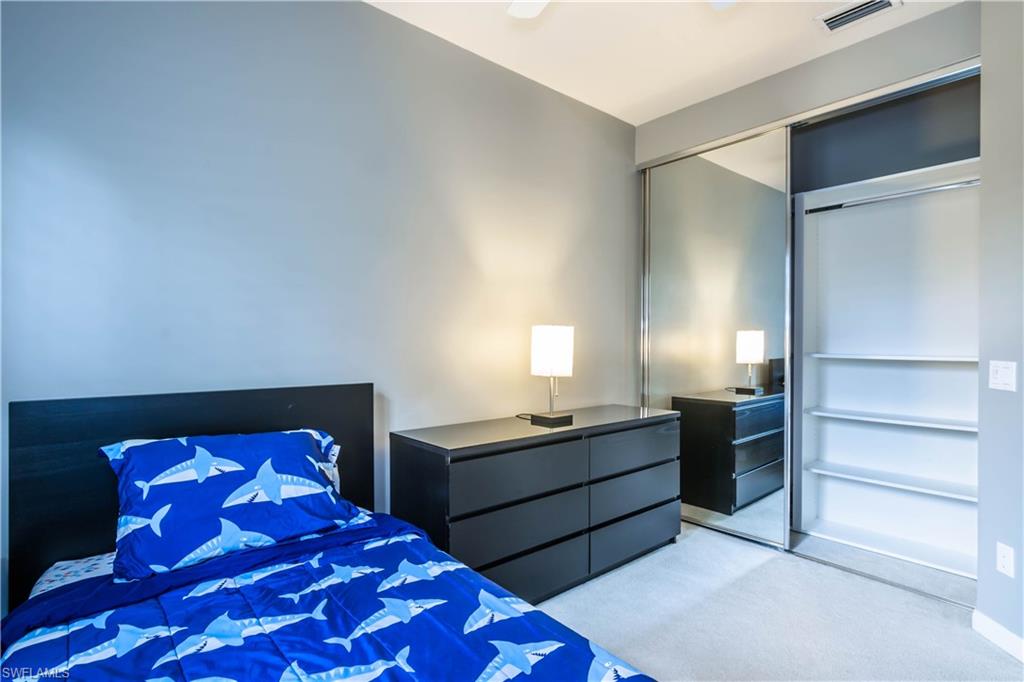 5441 Cove Circle Naples, FL 34119 - Photo 20 of 25 a bedroom with a bed and two dressers