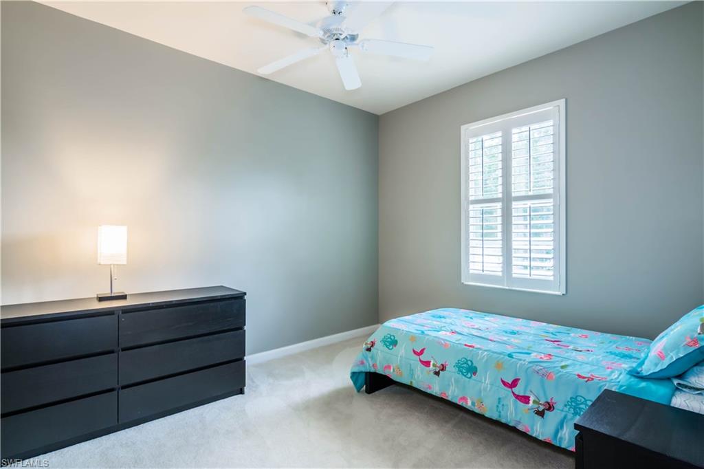 5441 Cove Circle Naples, FL 34119 - Photo 21 of 25 a bedroom with a bed and a window