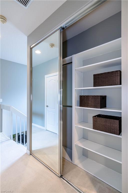 5441 Cove Circle Naples, FL 34119 - Photo 22 of 25 a view of walk in closet with empty racks