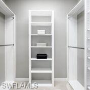 5441 Cove Circle Naples, FL 34119 - Photo 24 of 25 a view of walk in closet with empty racks