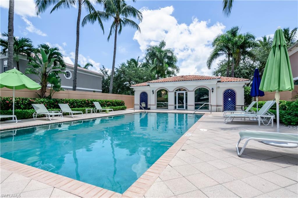 5441 Cove Circle Naples, FL 34119 - Photo 25 of 25 a swimming pool with outdoor seating and yard
