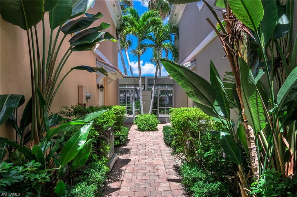 5441 Cove Circle Naples, FL 34119 - Photo 3 of 25 a view of a garden with plants