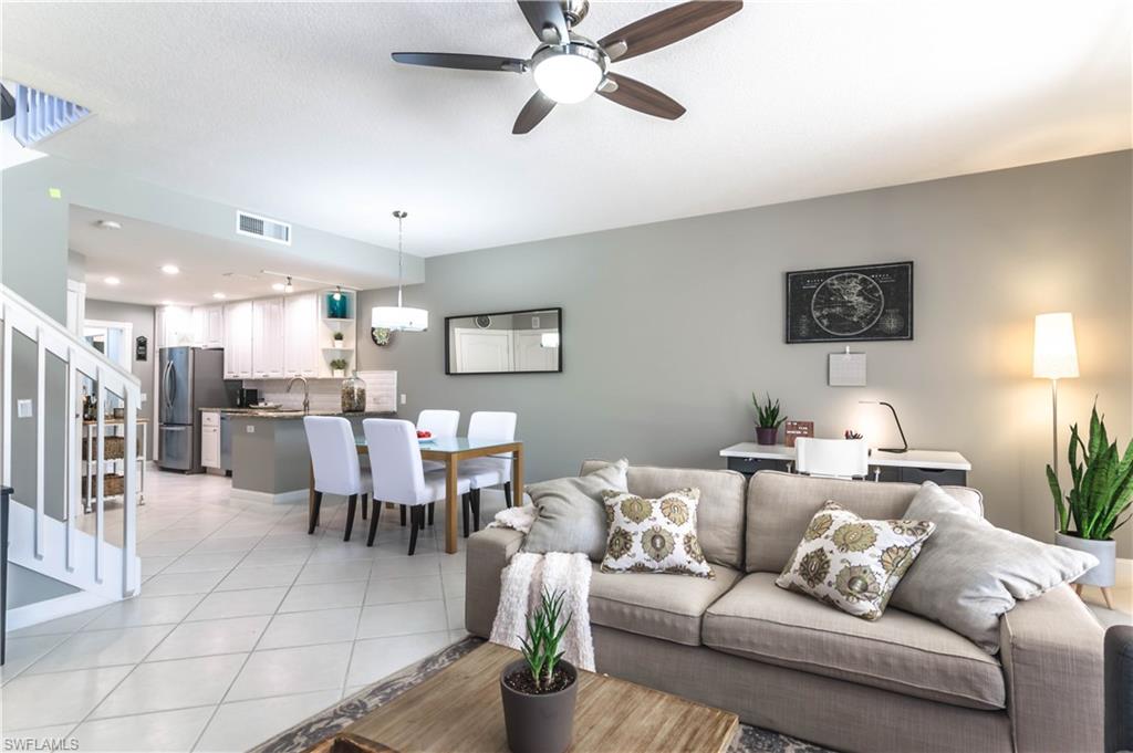 5441 Cove Circle Naples, FL 34119 - Photo 6 of 25 a living room with furniture kitchen view and a chandelier