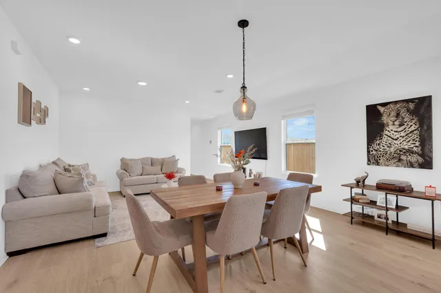 a kitchen with microwave a refrigerator and chairs