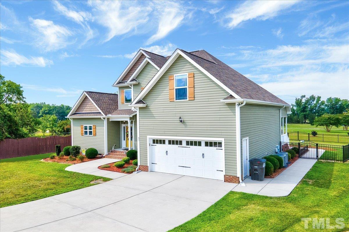 97 Baldwin Ridge Court Willow Spring, NC 27592 - Photo 2 of 46 a view of a house with a yard and a garden
