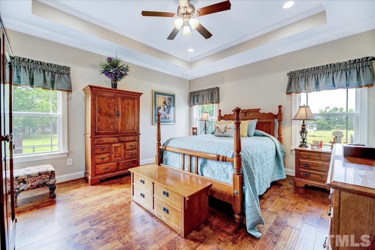 97 Baldwin Ridge Court Willow Spring, NC 27592 - Photo 21 of 46 a bedroom with furniture and a large window