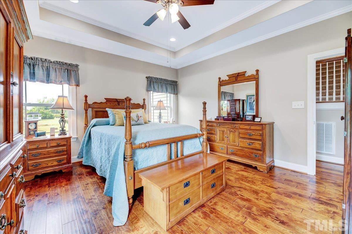 97 Baldwin Ridge Court Willow Spring, NC 27592 - Photo 22 of 46 a bedroom with furniture and a window