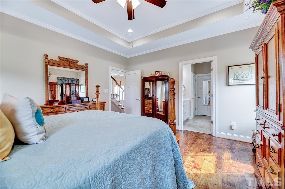 97 Baldwin Ridge Court Willow Spring, NC 27592 - Photo 23 of 46 a bed room with a bed and a television