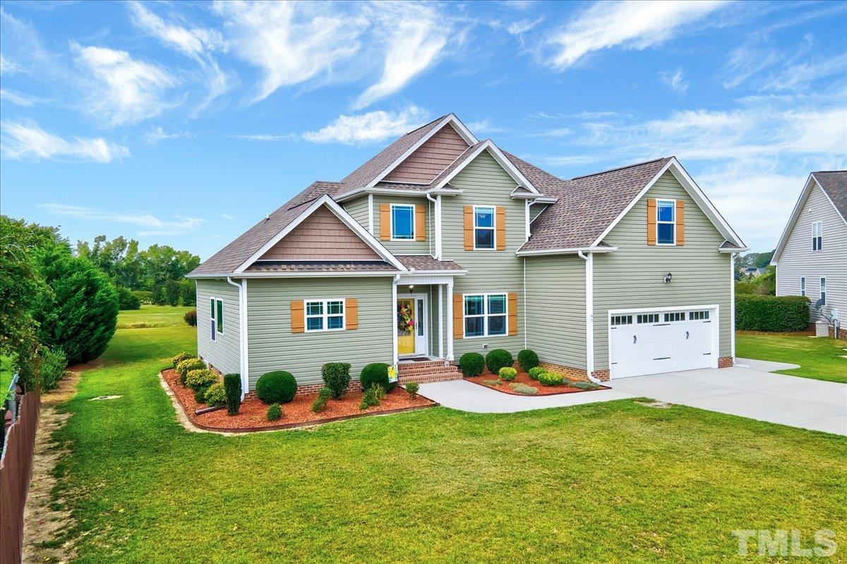 97 Baldwin Ridge Court Willow Spring, NC 27592 - Photo 3 of 46 a front view of a house with a yard and garage