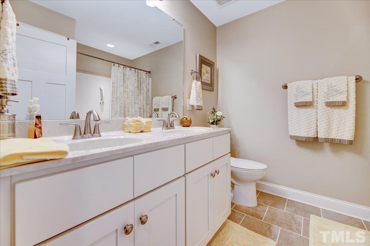 97 Baldwin Ridge Court Willow Spring, NC 27592 - Photo 31 of 46 a bathroom with a sink mirror vanity and toilet