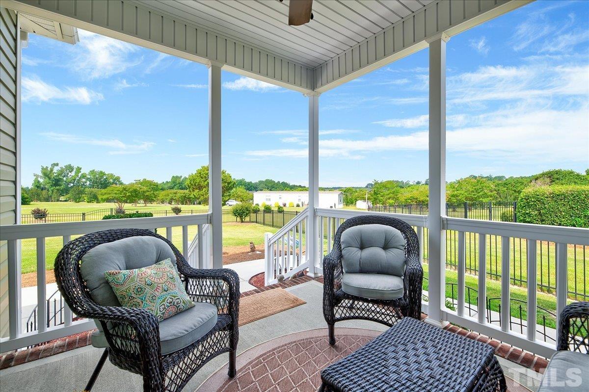 97 Baldwin Ridge Court Willow Spring, NC 27592 - Photo 33 of 46 a balcony view with a couch and a floor to ceiling window