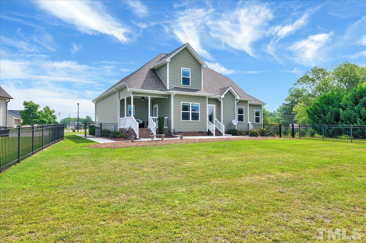 97 Baldwin Ridge Court Willow Spring, NC 27592 - Photo 36 of 46 a view of a house with a yard patio and swimming pool
