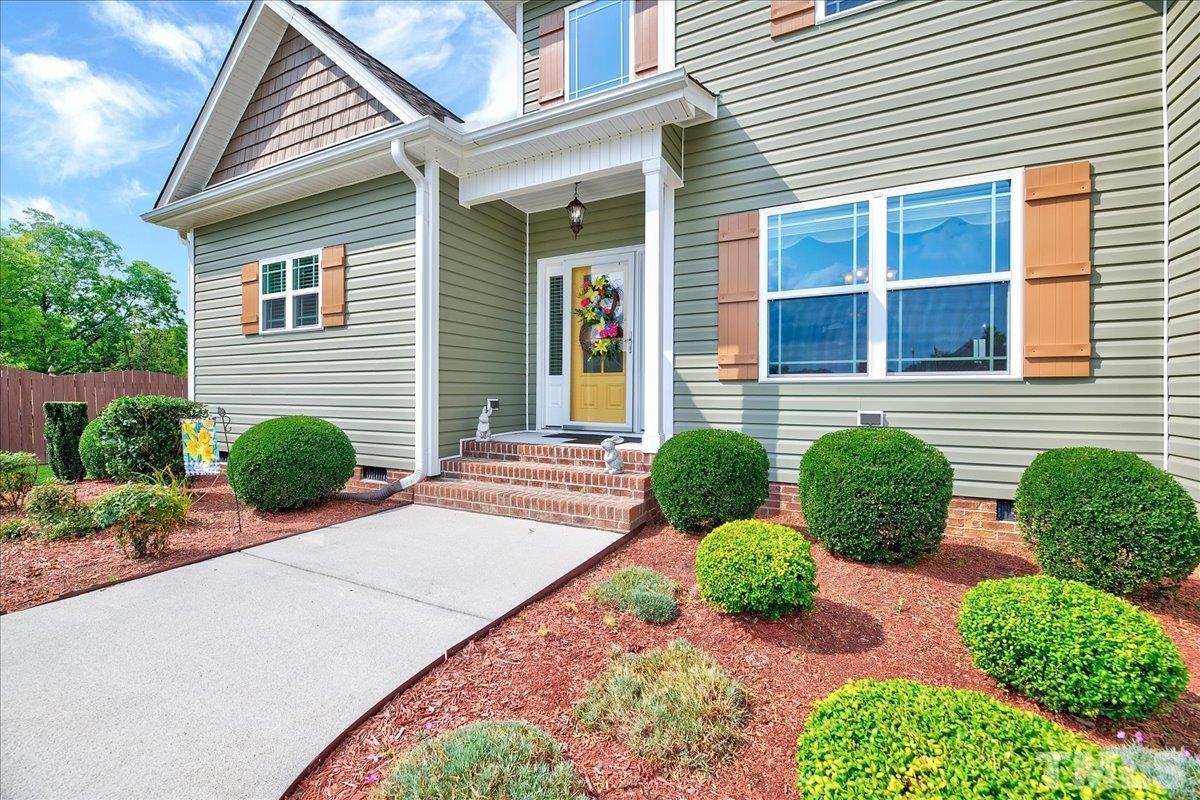 97 Baldwin Ridge Court Willow Spring, NC 27592 - Photo 4 of 46 a front view of a house with garden