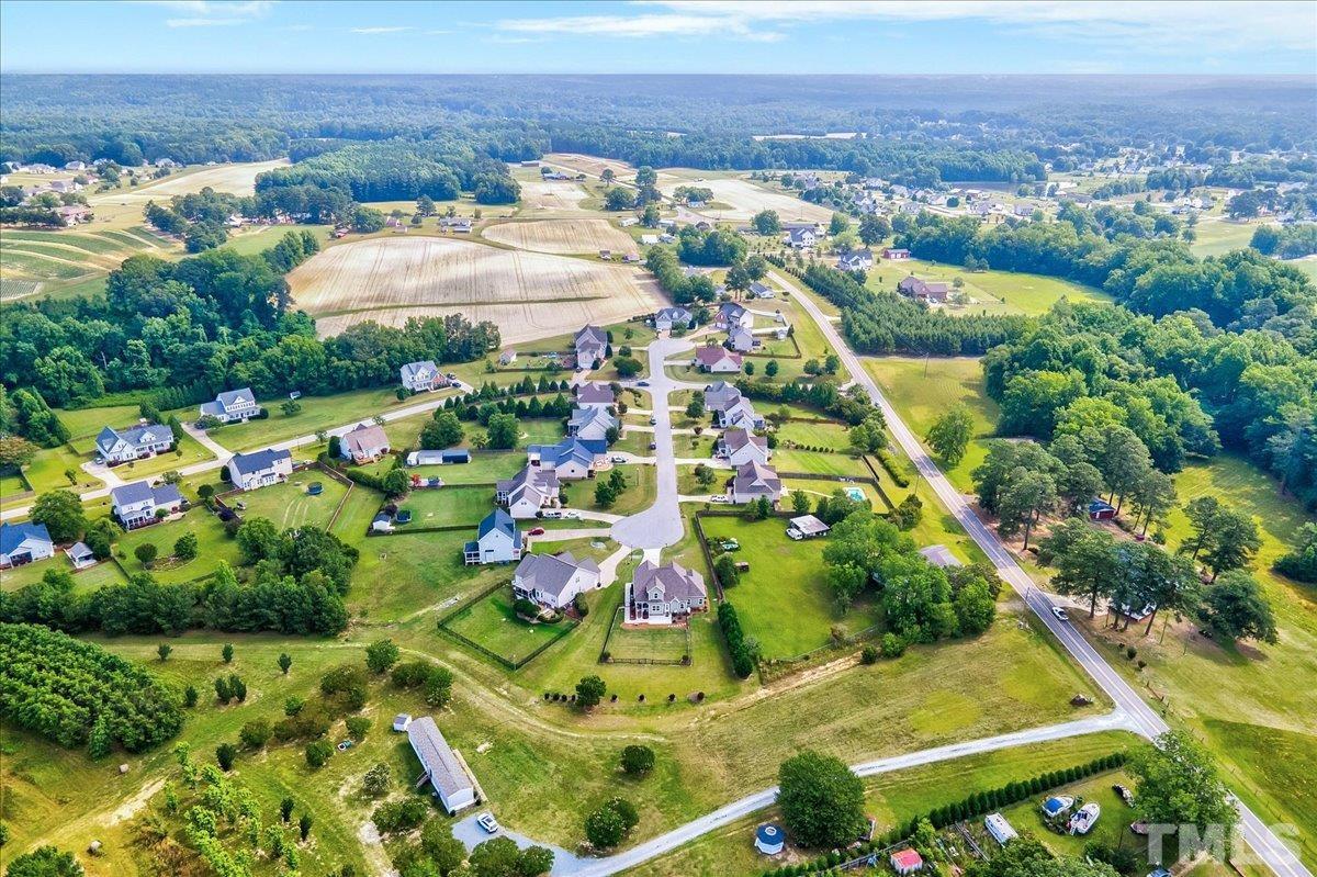 97 Baldwin Ridge Court Willow Spring, NC 27592 - Photo 43 of 46 an aerial view of residential houses with outdoor space and trees