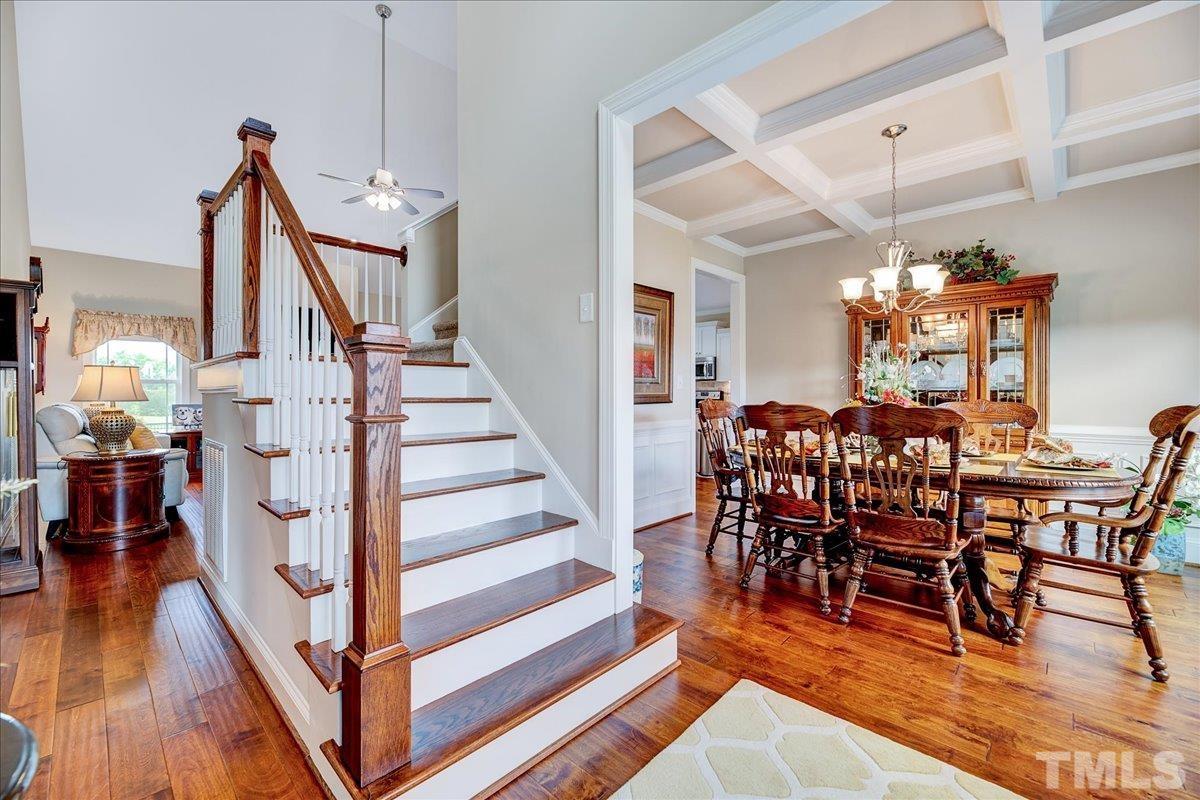 97 Baldwin Ridge Court Willow Spring, NC 27592 - Photo 5 of 46 a view of a dining room with furniture wooden floor and a chandelier
