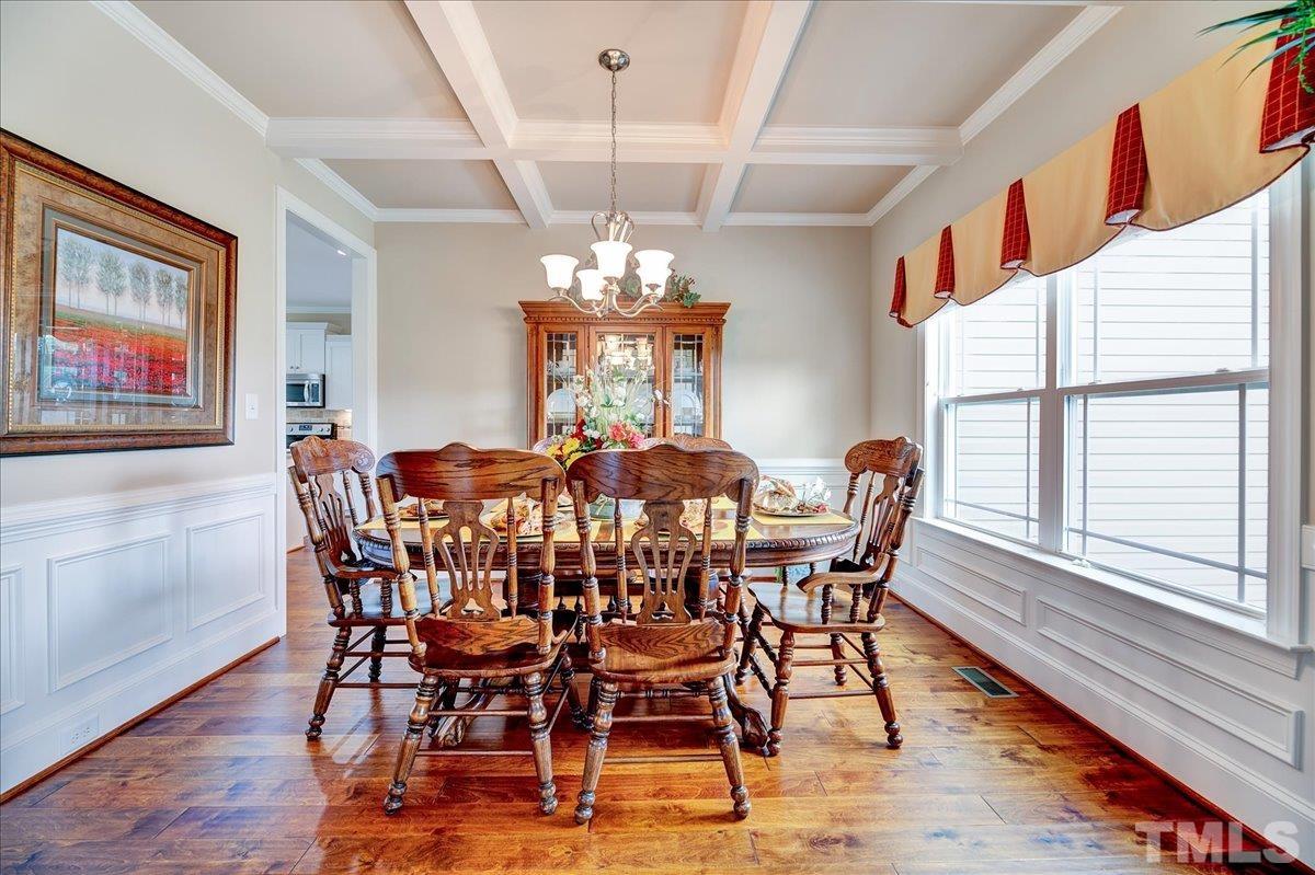 97 Baldwin Ridge Court Willow Spring, NC 27592 - Photo 7 of 46 a view of a dining room with furniture wooden floor and chandelier