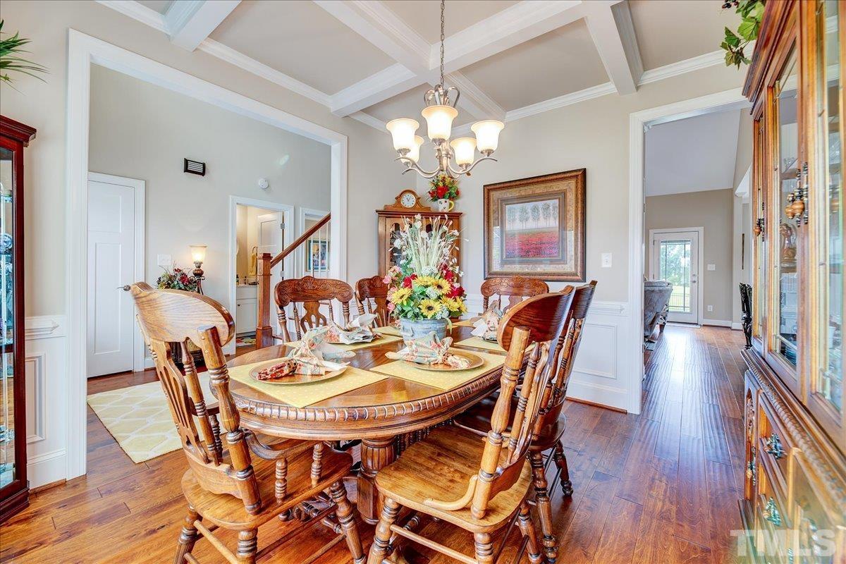 97 Baldwin Ridge Court Willow Spring, NC 27592 - Photo 8 of 46 a view of a dining room with furniture wooden floor and chandelier