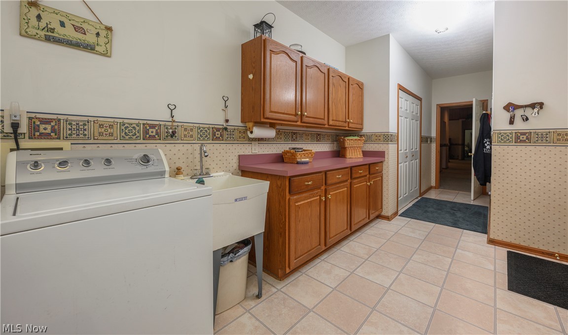 8745 Broadview Road Broadview Heights, OH 44147 - Photo 27 of 49 Functional laundry area featuring a utility sink, built-in cabinetry, and tile flooring