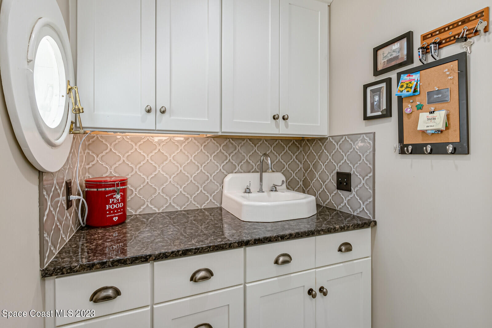 709 Rockledge Drive Rockledge, FL 32955 - Photo 48 of 102 a kitchen with granite countertop white cabinets and a wooden floor