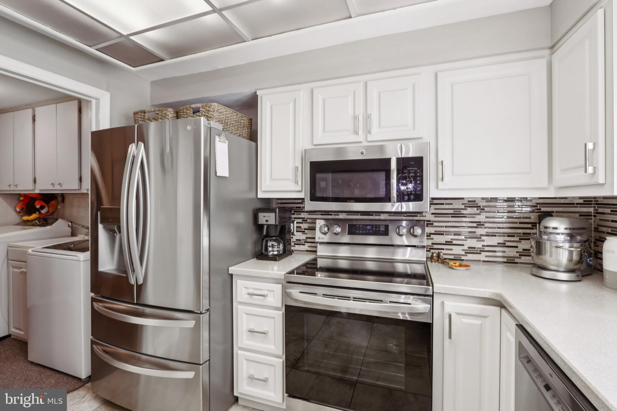 102 Partree Road Cherry Hill, NJ 08003 - Photo 32 of 87 a kitchen with refrigerator microwave and stove