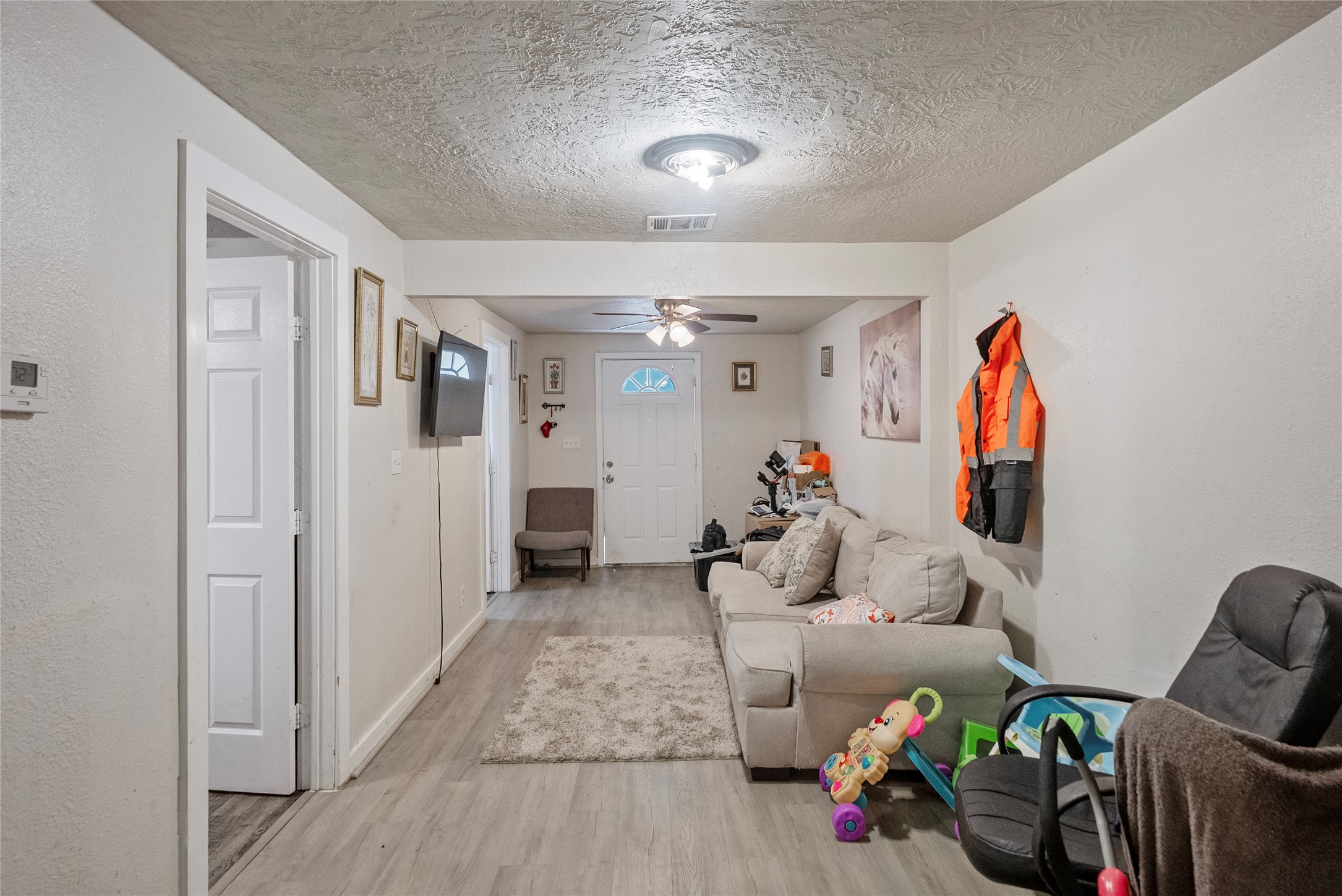 7938 Kerr Street, Unit 6 Houston, TX 77029 - Photo 7 of 18 a living room with furniture and a gym equipment