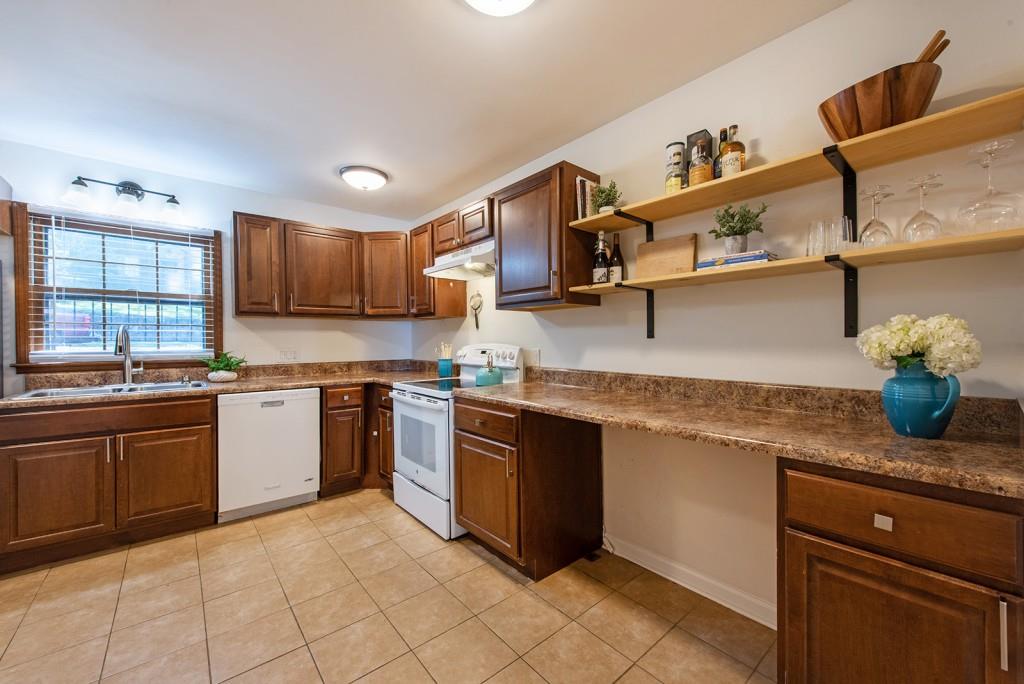 408 Sycamore Drive, Unit D Decatur, GA 30030 - Photo 11 of 63 a kitchen with stainless steel appliances granite countertop a sink stove and cabinets