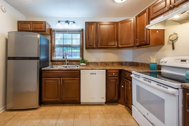 a kitchen with a sink stove and cabinets
