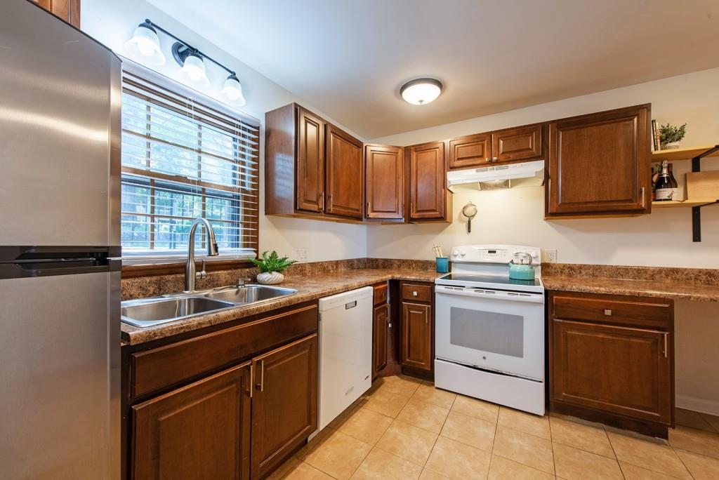 408 Sycamore Drive, Unit D Decatur, GA 30030 - Photo 13 of 63 a kitchen with a sink stove and cabinets