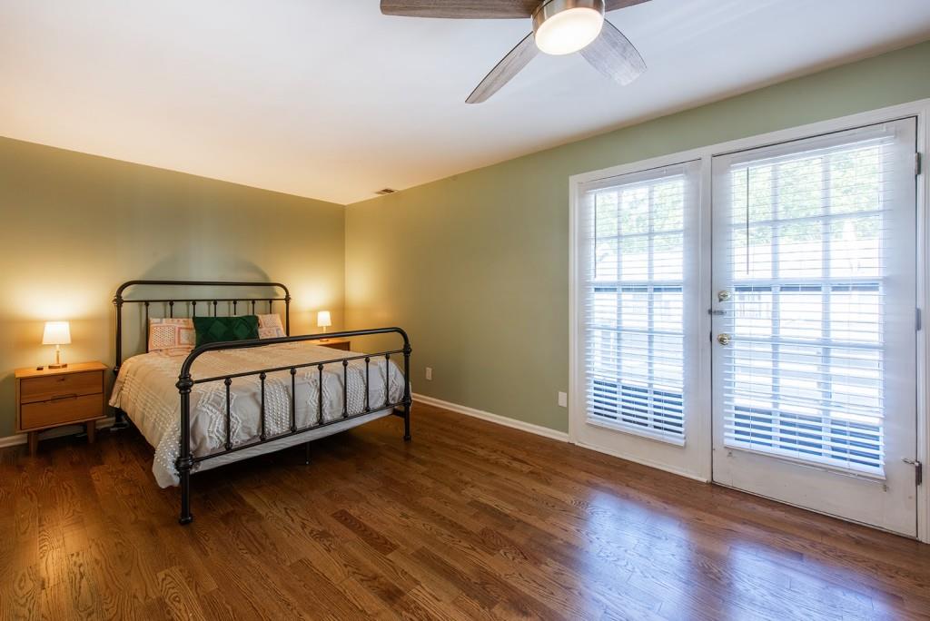 408 Sycamore Drive, Unit D Decatur, GA 30030 - Photo 15 of 63 a bedroom with a bed and wooden floor