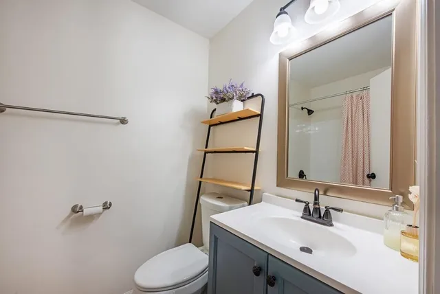 a view of a house with wooden deck and furniture