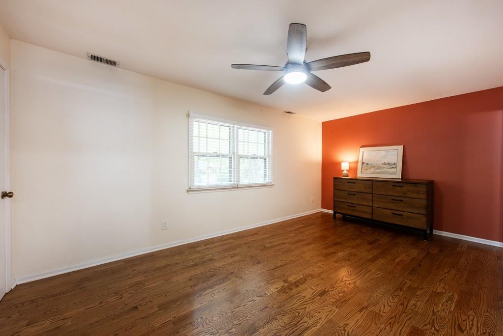 408 Sycamore Drive, Unit D Decatur, GA 30030 - Photo 24 of 63 an empty room with wooden floor ceiling fan and windows