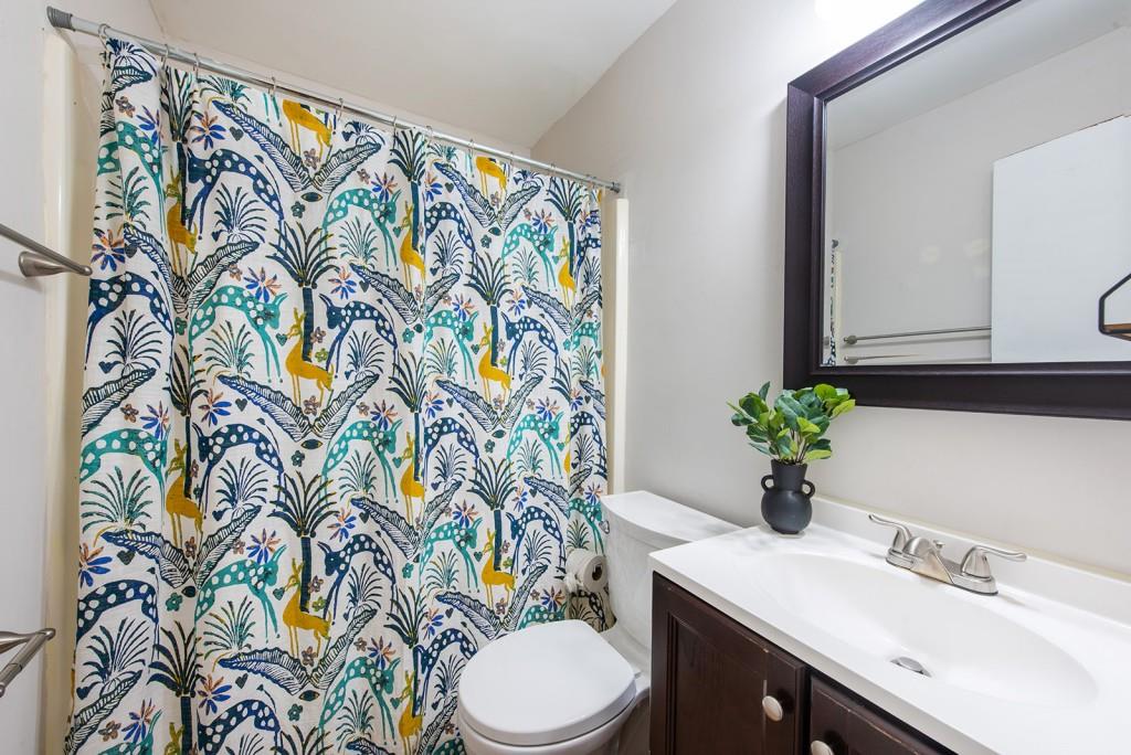408 Sycamore Drive, Unit D Decatur, GA 30030 - Photo 25 of 63 a bathroom with a sink mirror vanity and toilet