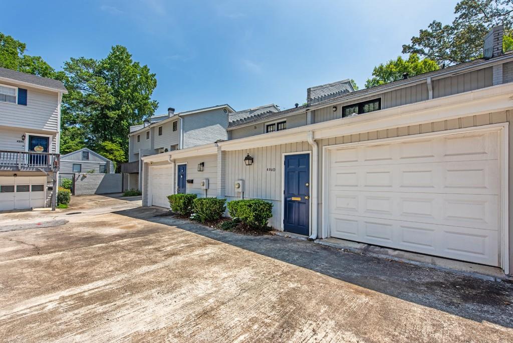 408 Sycamore Drive, Unit D Decatur, GA 30030 - Photo 30 of 63 a view of a white house with a yard and potted plants
