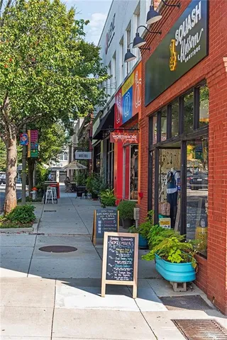 a view of a patio with a table and chairs under an umbrella
