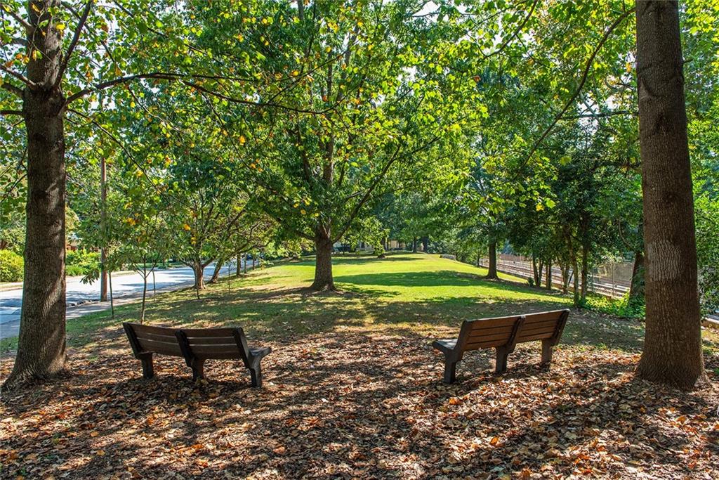 408 Sycamore Drive, Unit D Decatur, GA 30030 - Photo 59 of 63 a park view with a bench and trees in the background