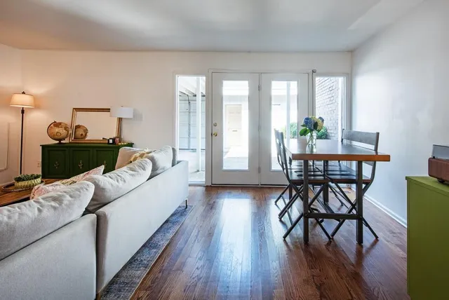 a living room with furniture and wooden floor