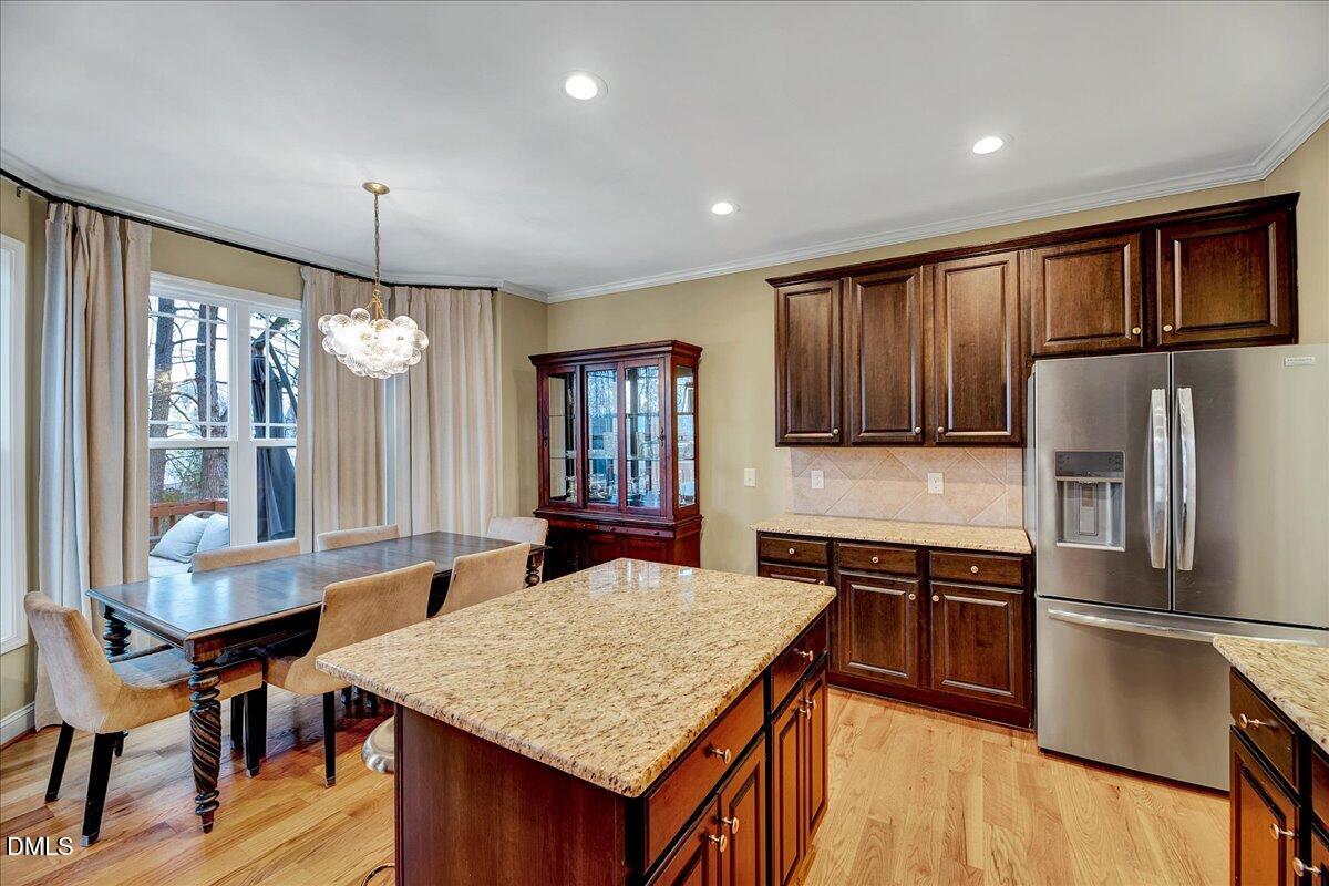 454 Big Willow Way Rolesville, NC 27571 - Photo 16 of 50 a kitchen with stainless steel appliances granite countertop a stove refrigerator sink and cabinets