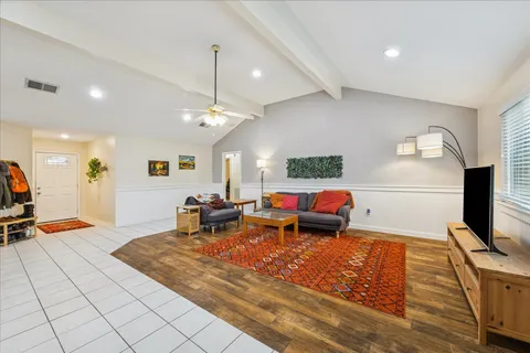 a living room with lots of furniture and a flat screen tv