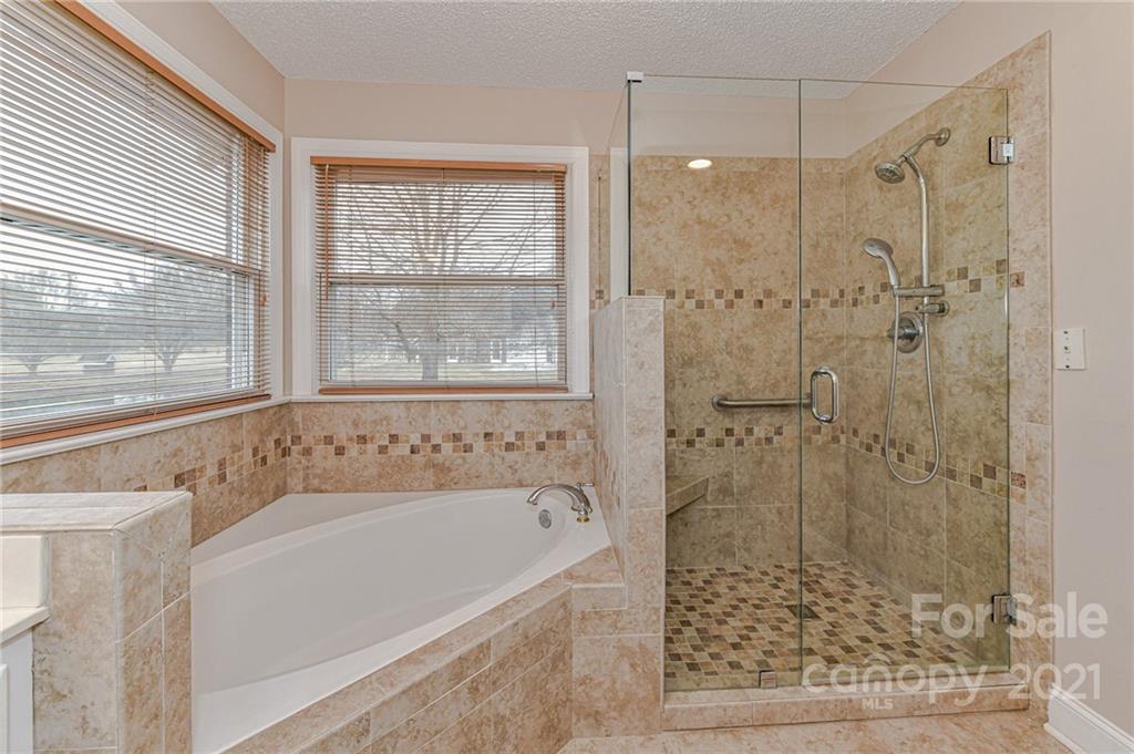 4014 Love Mill Road Monroe, NC 28110 - Photo 7 of 16 a bathroom with a bathtub and a shower