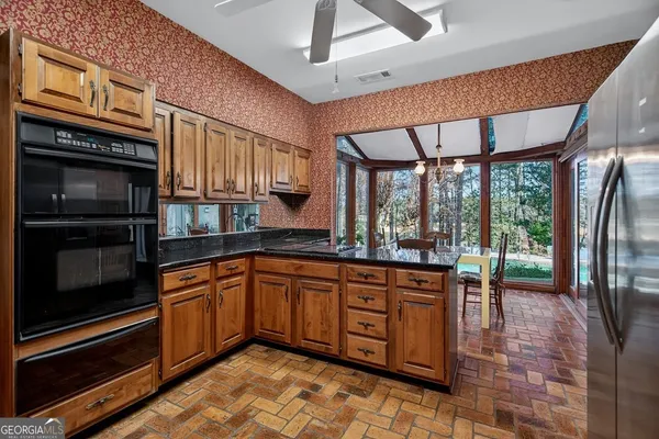 a kitchen with stainless steel appliances granite countertop a stove sink and cabinets