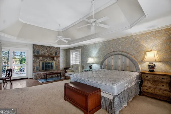 a bedroom with a bed a couch and dresser